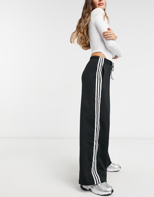 Adidas Originals Adicolor Three Stripe Wide Leg Pants In Black Asos Tiglio luxe wide leg pants feature extrafine wool fabrics, double inverted pleats, flap back pockets, and buttoned front belt loops. adidas originals adicolor three stripe wide leg pants in black