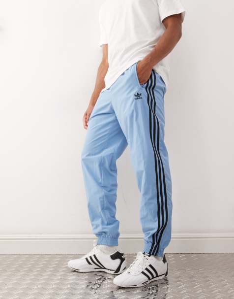 adidas Originals Adicolor woven firebird track pants in ash blue / black - view 1