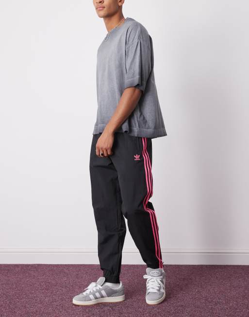 adidas Originals Adicolor woven firebird track pants in black / lucid pink