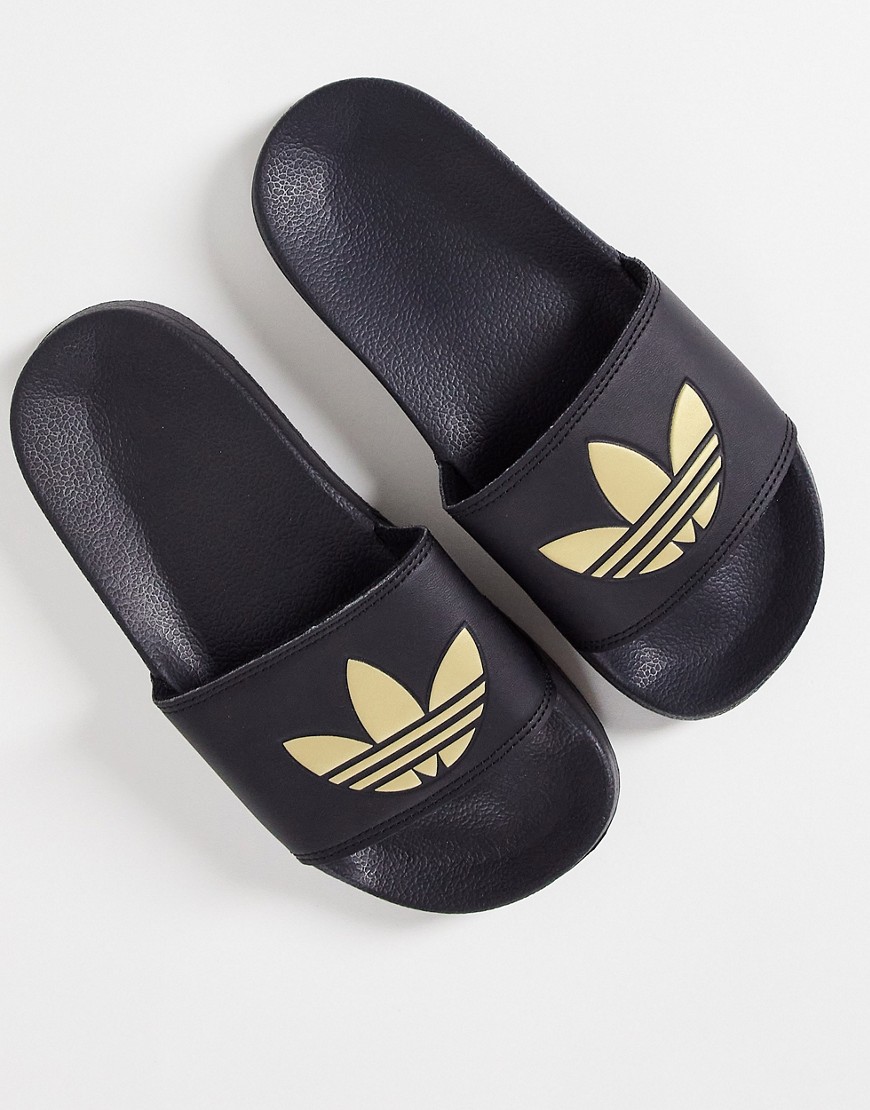 adidas Originals Adilette lite sliders in black with gold trefoil
