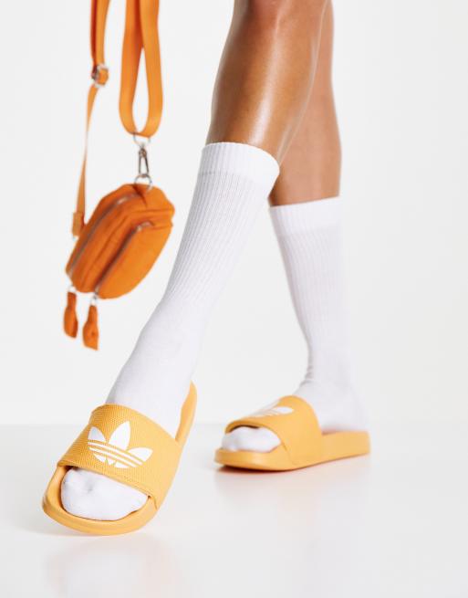 adidas Originals Adilette Lite slides in hazy orange ASOS