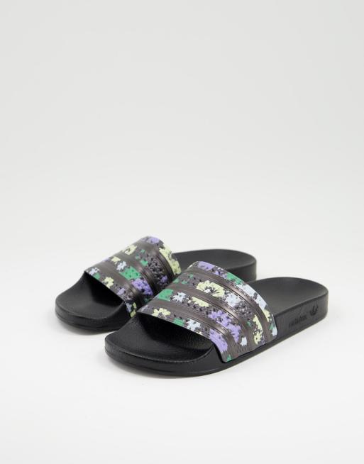 adidas Originals Adilette sliders in black with acid floral print