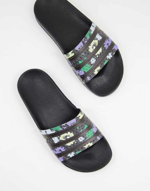 adidas Originals Adilette sliders in black with acid floral print