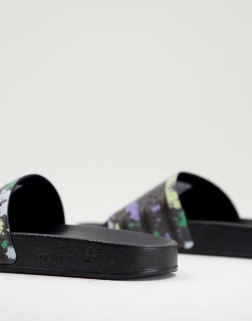 adidas Originals Adilette sliders in black with acid floral print