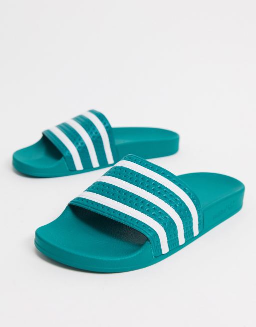 adidas Originals Adilette sliders in green and white