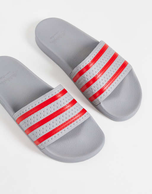 adidas Originals Adilette sliders in grey and red