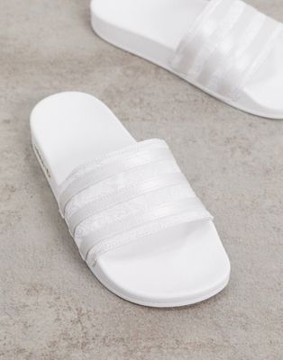 white and silver adidas sliders