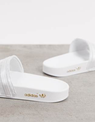 white and silver adidas sliders