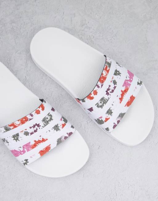 adidas Originals Adilette sliders in white with acid floral print