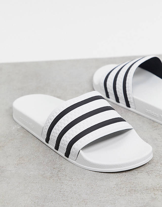adidas Originals - adilette sliders in white with black stripes