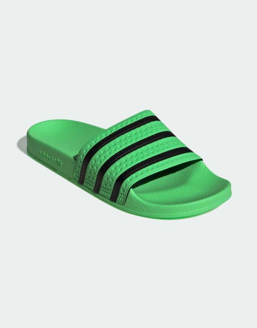 adidas Originals Adilette slides in screaming green / core black / screaming green