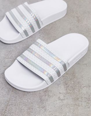 white and silver adidas slides