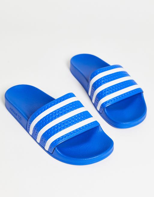 Tot stand brengen Ijveraar Machtigen adidas Originals - Adilette - Slippers in blauw | ASOS