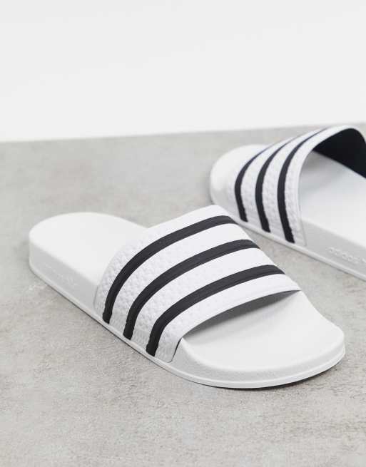 Eigen plaats aanraken adidas Originals - Adilette - Slippers in wit met zwarte strepen | ASOS