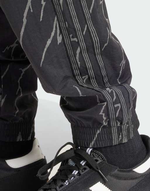 adidas Originals Allover print SST tracksuit bottoms in Black