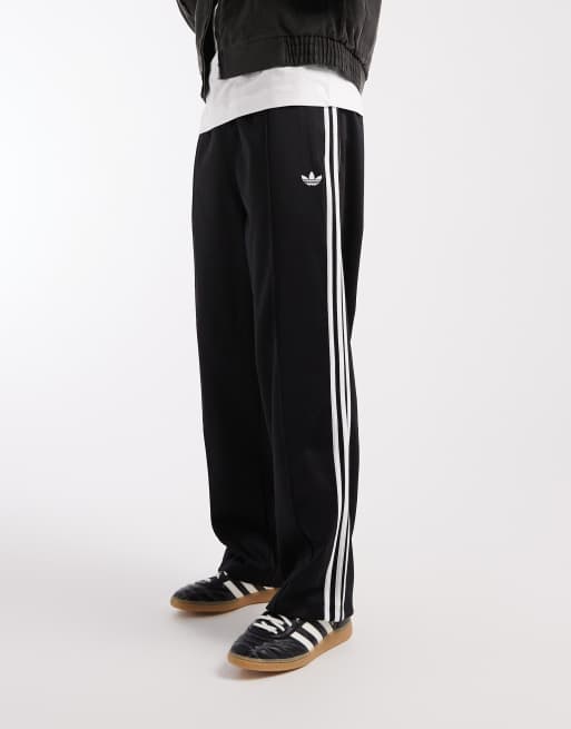 adidas Originals - Baggy og sorte træningsbukser med hvide striber