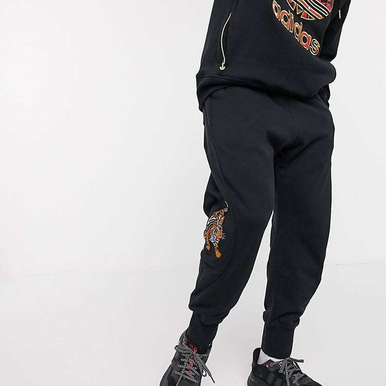 adidas Originals chinese new year sweatpants with tiger print in black