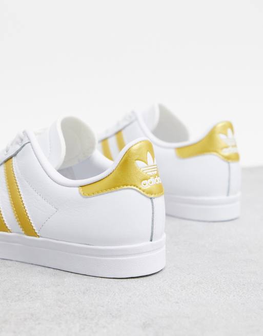 Adidas white shoes sales with gold stripes