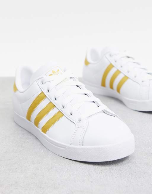 White shoes with gold 2024 stripes