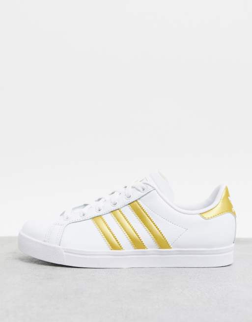 Adidas wit met store gouden strepen