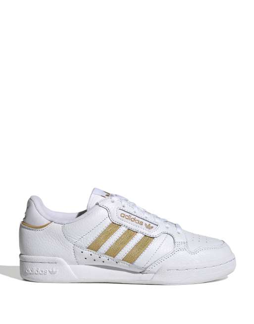 Adidas scarpe bianche store e oro