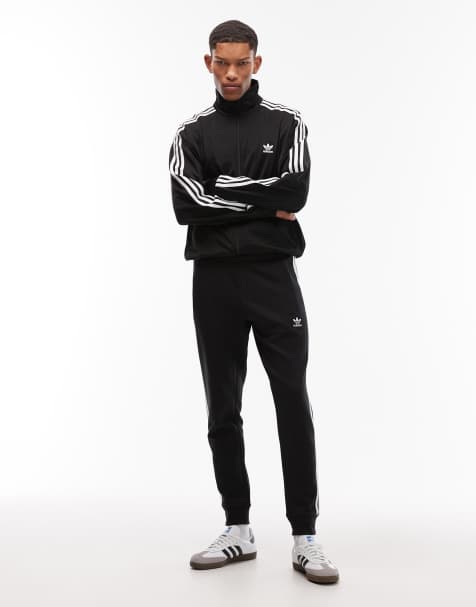 adidas Originals three stripe joggers in black
