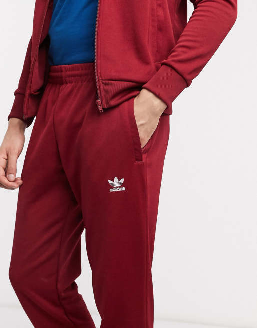 Adidas essential store track pants maroon