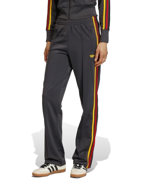 adidas Originals Firebird classic track pants in black and gold - view 1