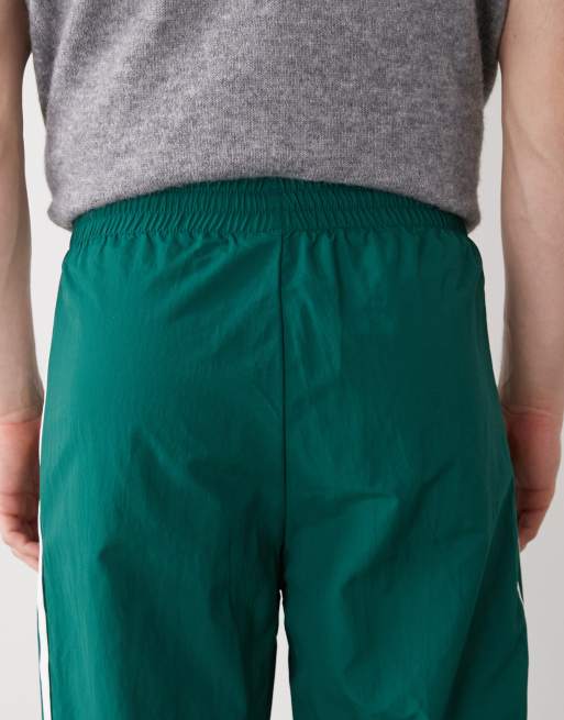 adidas Originals – Firebird – Gewebte Trainingshose in Collegiate Green, 5 von 5