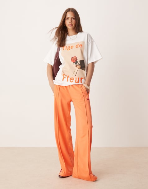 adidas Originals – Firebird – Locker geschnittene Trainingshose in Orange - view 1