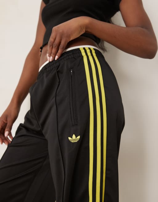adidas Originals Firebird loose track pants in black and yellow 