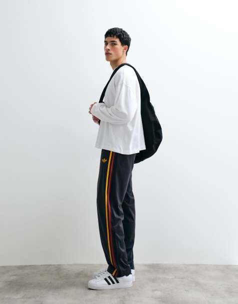 adidas Originals firebird track pants in black and gold