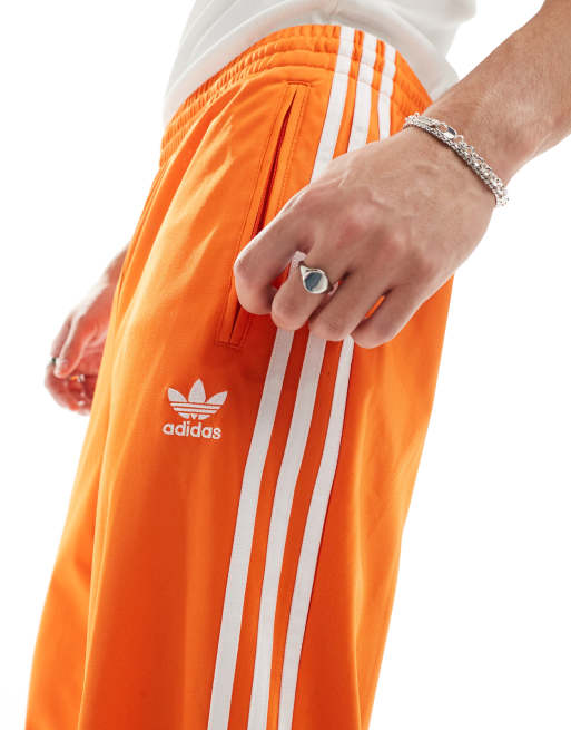 adidas Originals Firebird track pants in orange