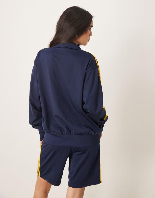 adidas Originals Firebird track top in navy and yellow