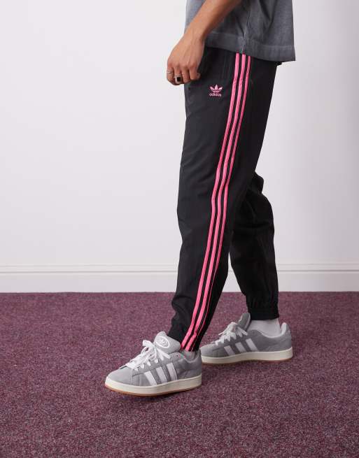adidas Originals Firebird track pants in black and bright pink