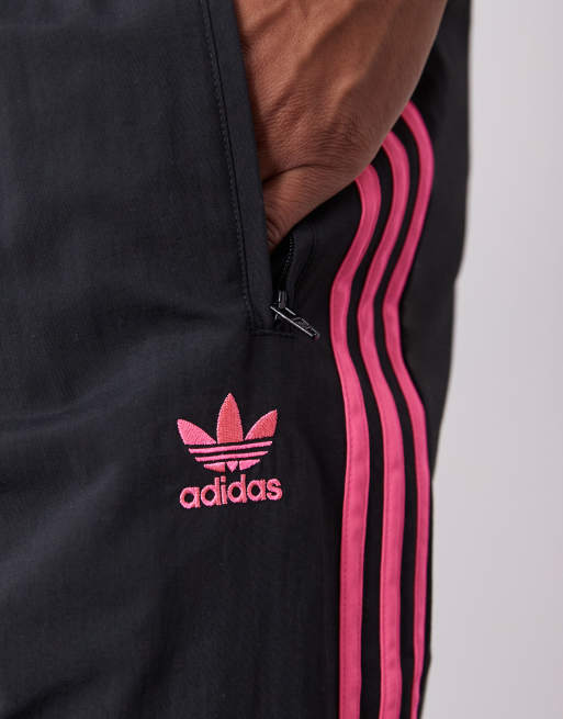 adidas Originals Firebird track pants in black and bright pink