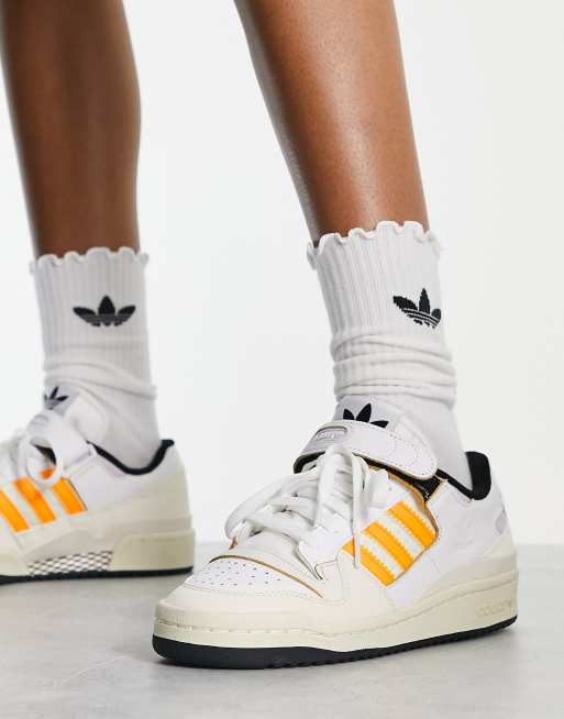 White adidas with orange hot sale stripes