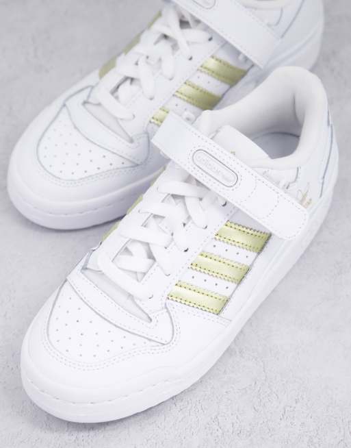 Adidas sneakers with gold 2025 stripes