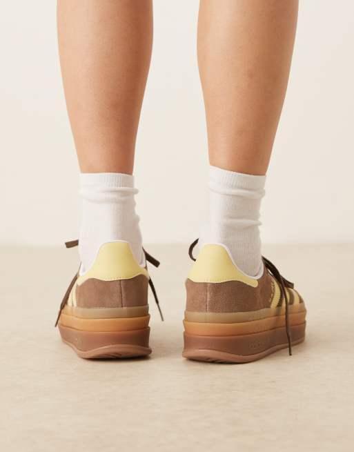 adidas Originals Gazelle Bold platform trainers in brown and yellow