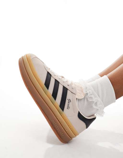 Tan and store black adidas