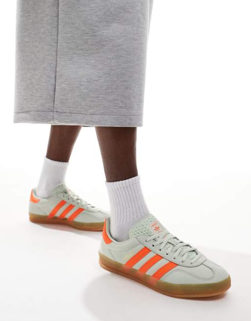 adidas Originals Gazelle Indoor trainers in light green and orange with gum sole