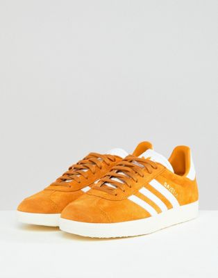 mustard coloured adidas trainers