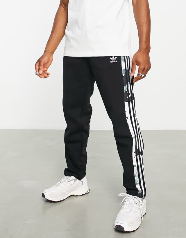 adidas Originals Graphics camo three stripe sweatpants in black