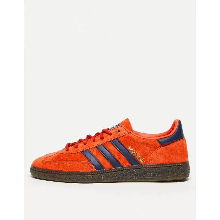 Adidas trainers blue sales with orange stripes