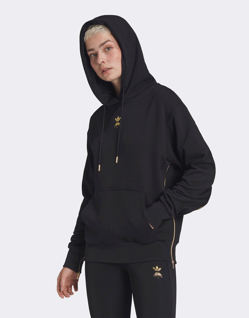 adidas Originals hoodie in black with gold logo and zipper detail