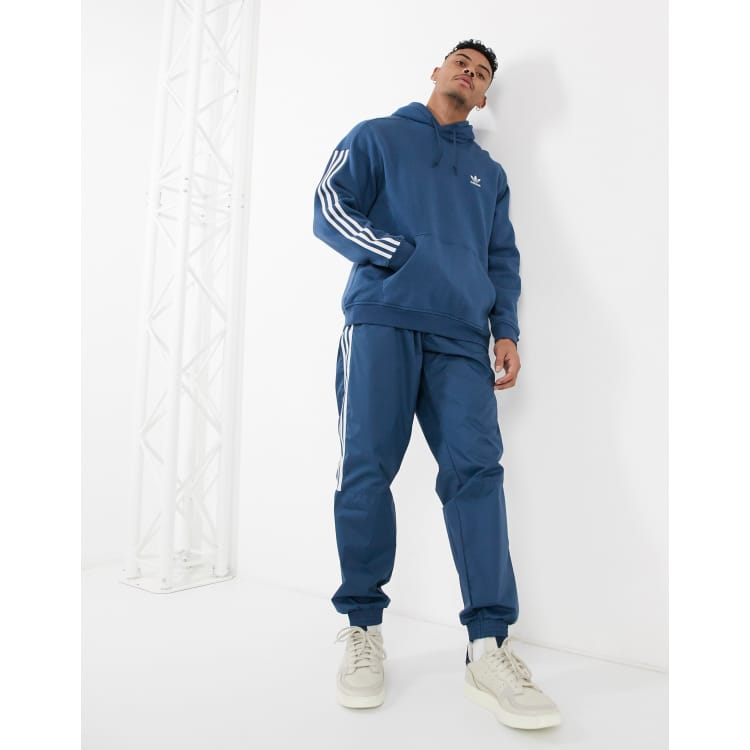 Adidas originals hoodie with tech logo deals in navy