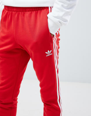 adidas Originals - Joggers skinny rossi con 3 strisce e fondo elasticizzato  DH5837 | ASOS