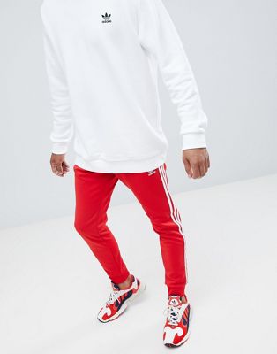 adidas Originals - Joggers skinny rossi con 3 strisce e fondo elasticizzato  DH5837 | ASOS