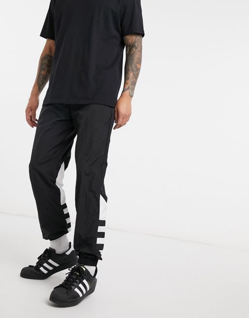 adidas Originals large trefoil print joggers in black