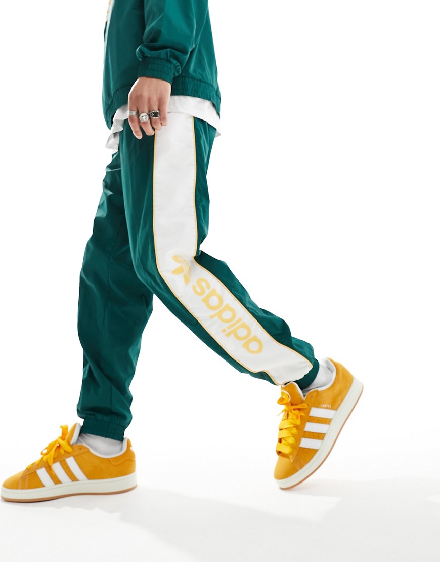 adidas Originals linear logo joggers in dark green and yellow
